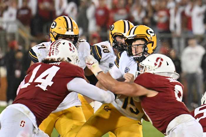 Nov 18, 2023; Stanford, California, USA; California Golden Bears quarterback Fernando Mendoza (15) is hit by Stanford Cardinal linebacker Tristan Sinclair (8) during the third quarter at Stanford Stadium. Sinclair was penalized for targeting on the play. Mandatory Credit: Robert Edwards-USA TODAY Sports